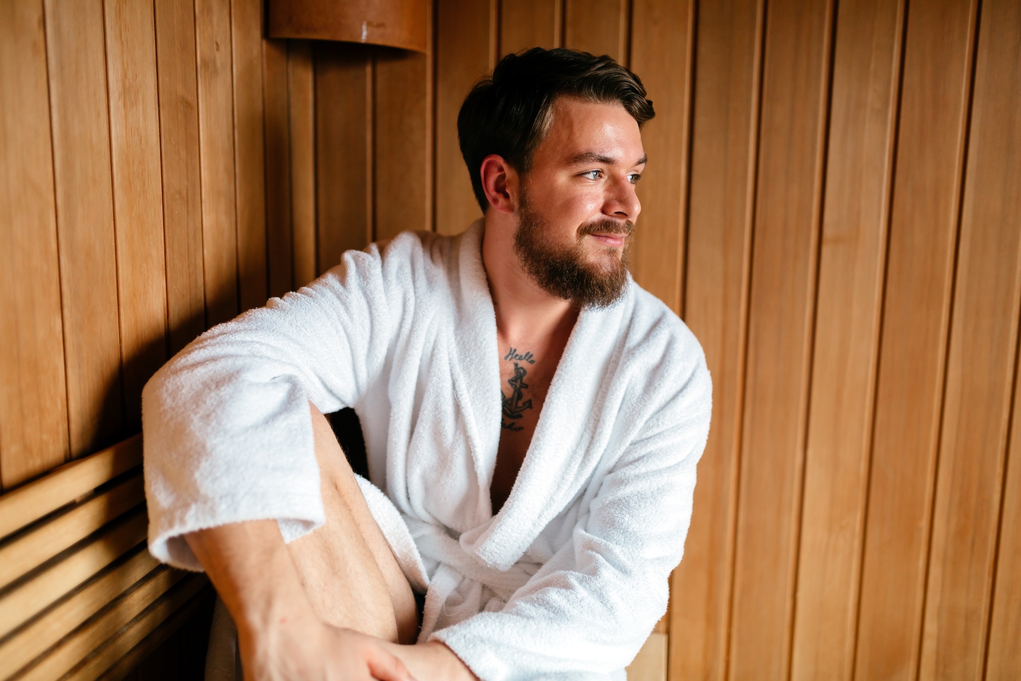 Handsome man relaxing in sauna